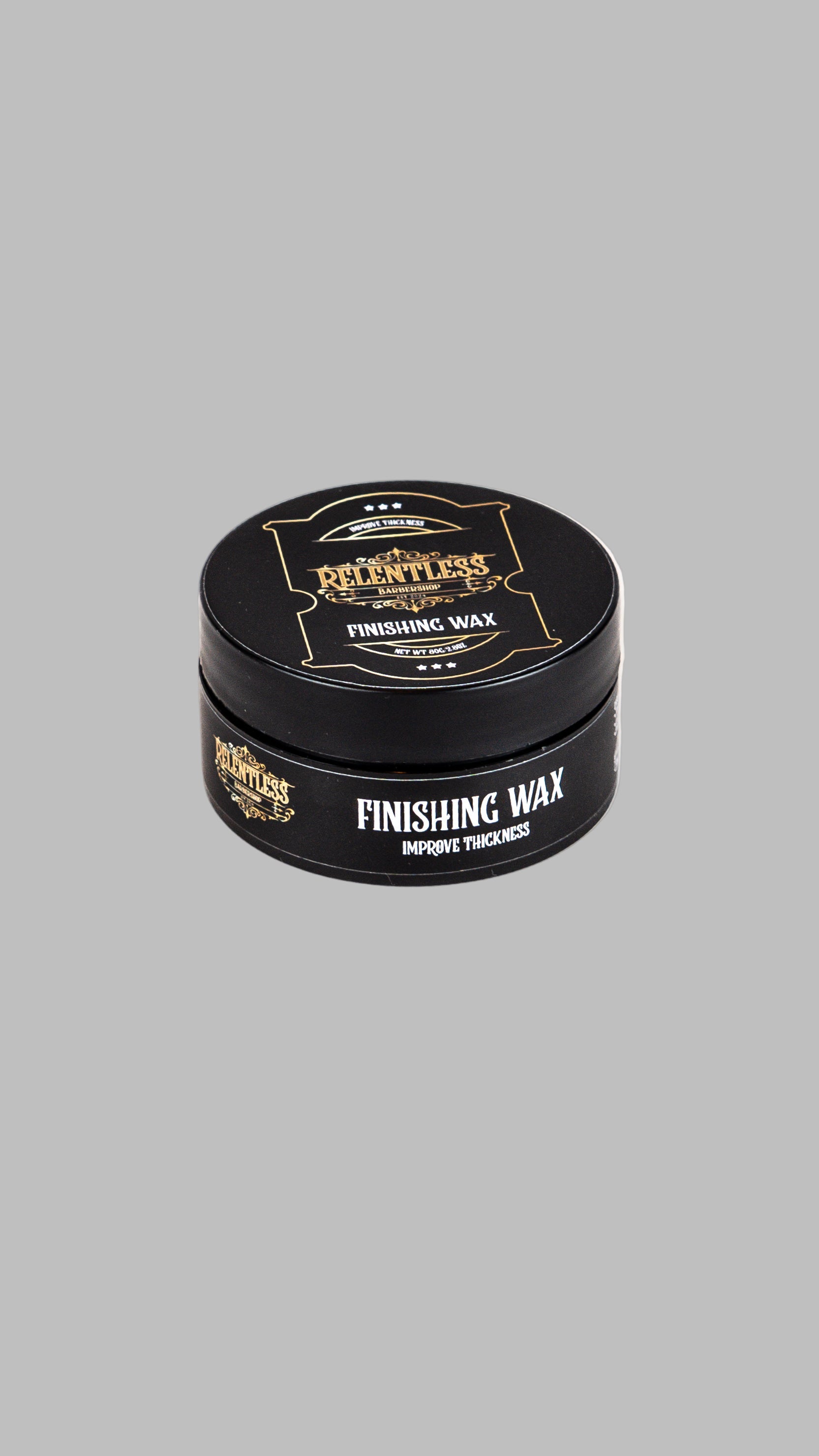 Finishing wax container with black lid and body on a white background